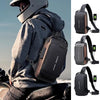 Person wearing a black crossbody bag with USB charging port, sitting on a motorcycle.