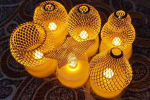 String lights with mesh-covered bulbs on a textured surface