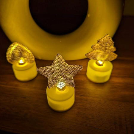 Decorative string lights with star and tree shapes on a wooden surface.