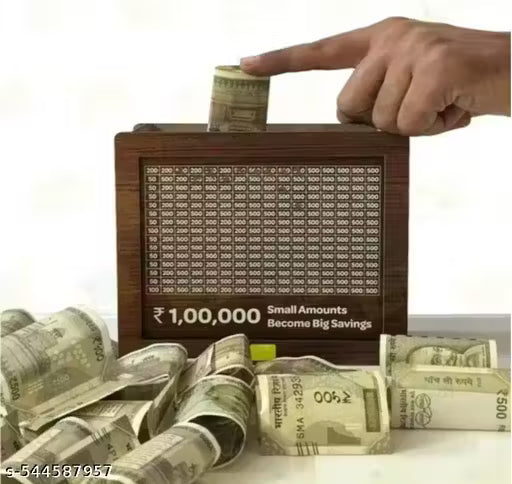 Wooden money box with currency notes and a hand placing money into it, on a white background.